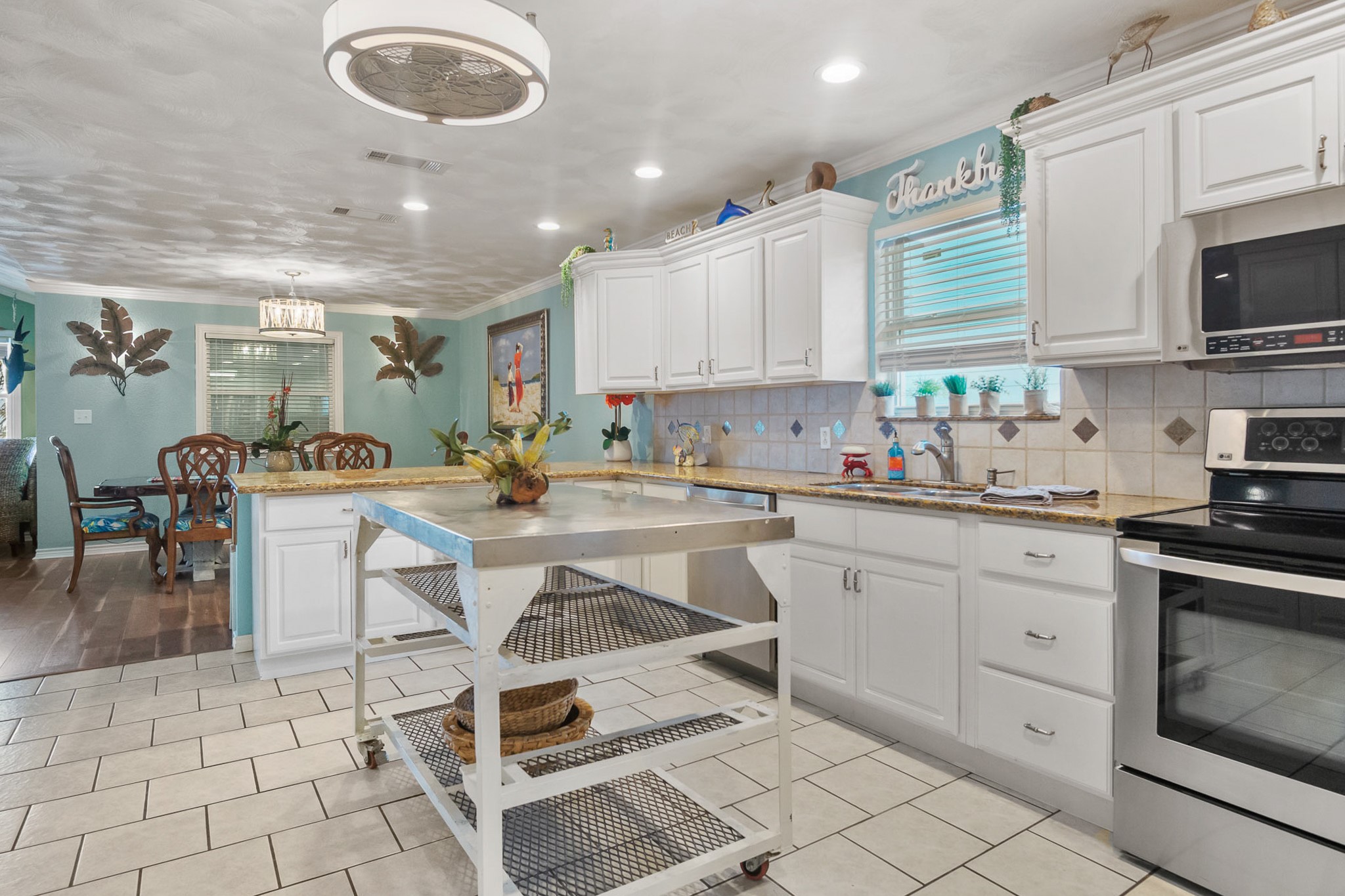 3297 Prides Way Crystal Beach, TX 77650 - Photo 14 of 42 a kitchen with table chairs and cabinets