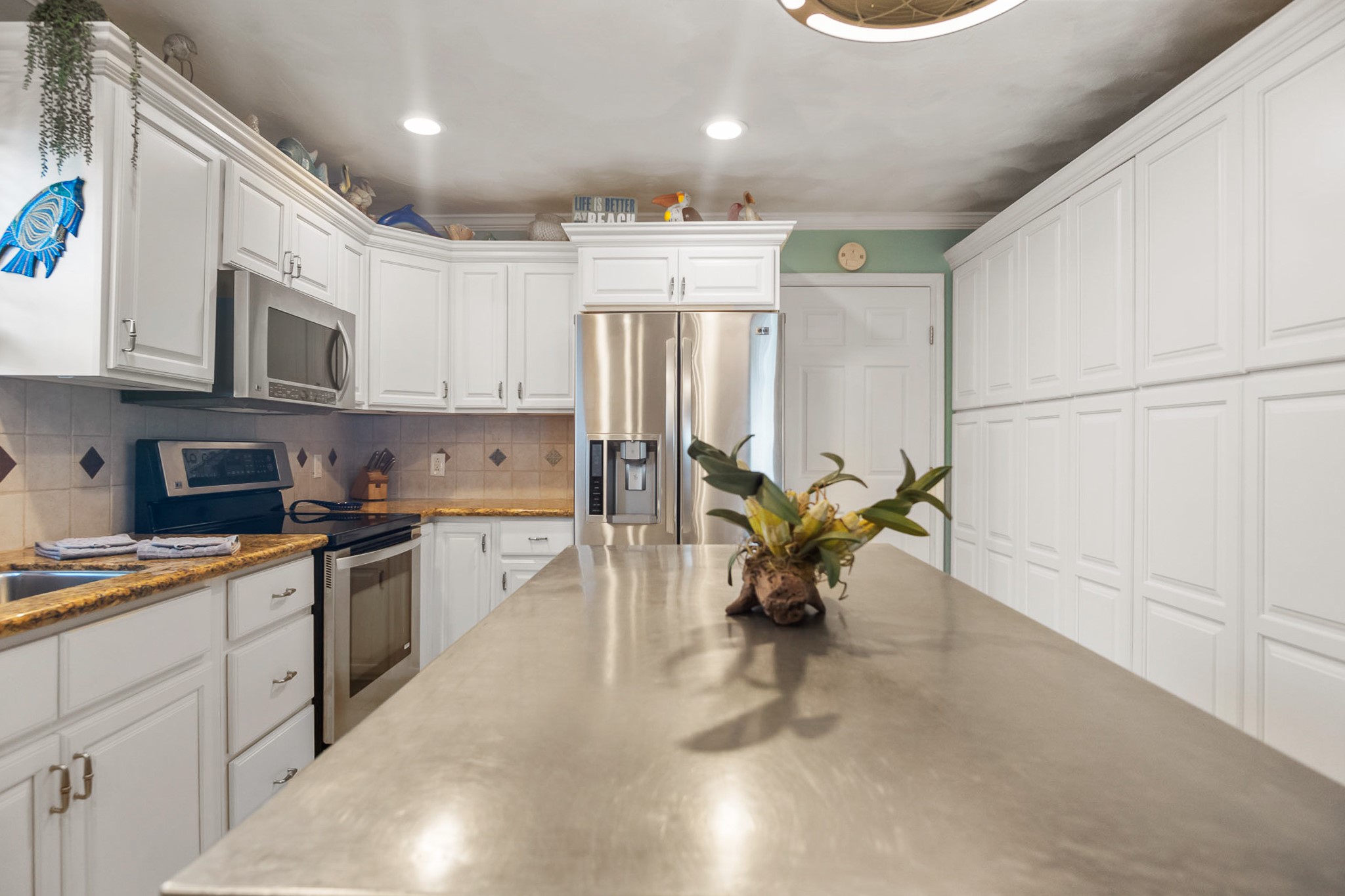 3297 Prides Way Crystal Beach, TX 77650 - Photo 16 of 42 a kitchen with stainless steel appliances granite countertop a refrigerator and a stove top oven