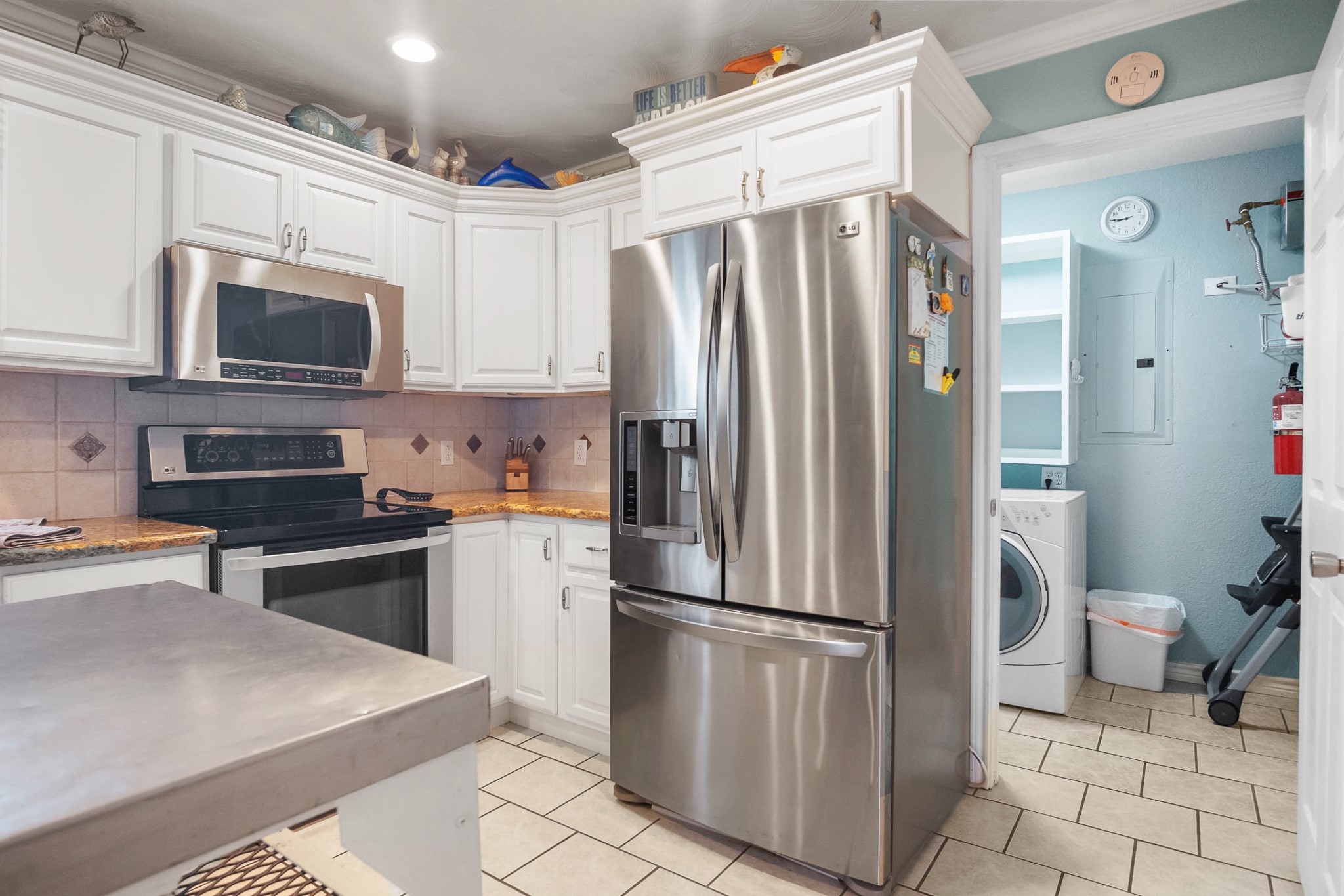 3297 Prides Way Crystal Beach, TX 77650 - Photo 18 of 42 a kitchen with stainless steel appliances a refrigerator sink and microwave