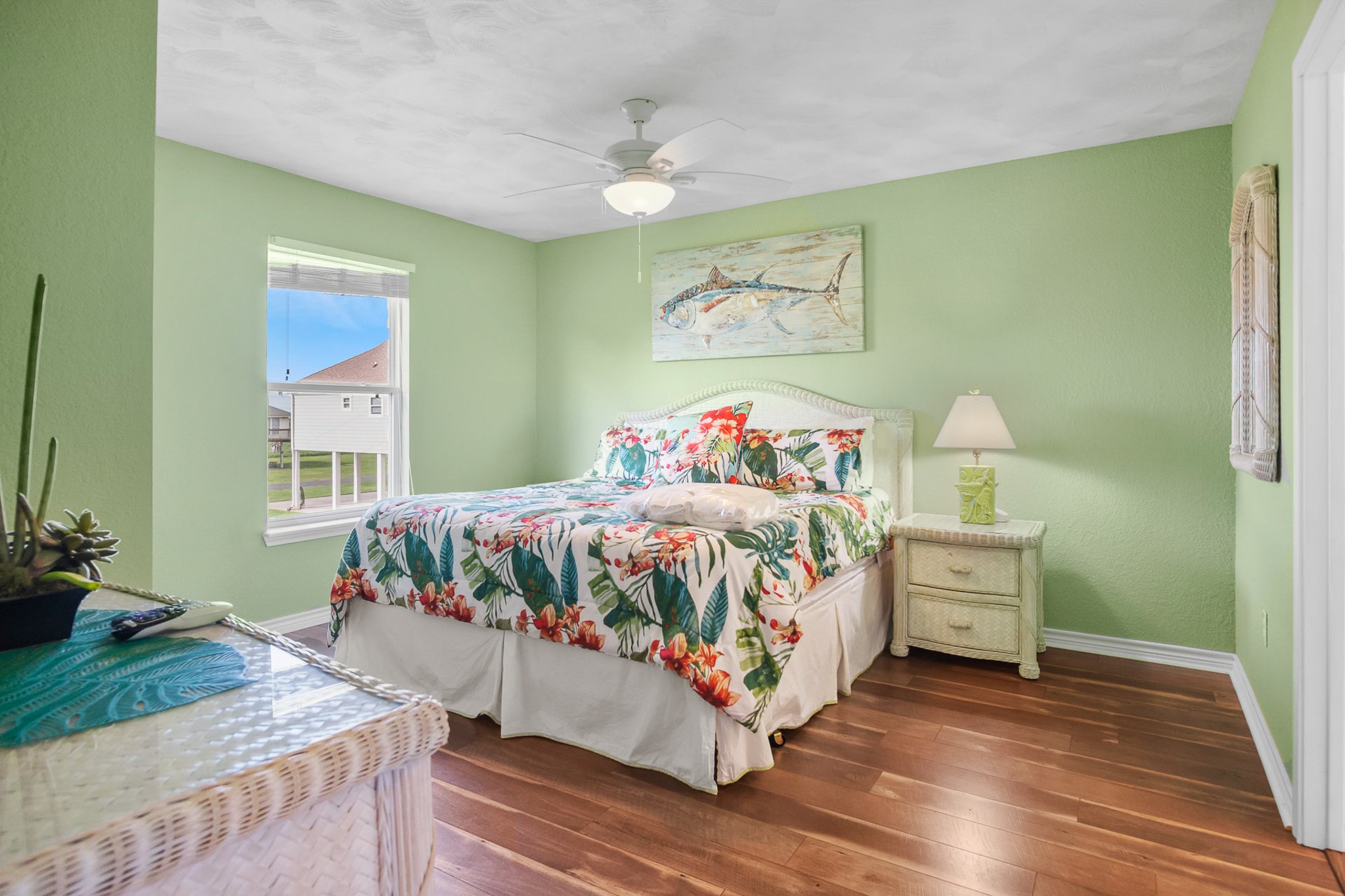 3297 Prides Way Crystal Beach, TX 77650 - Photo 22 of 42 a bedroom with a bed and wooden floor