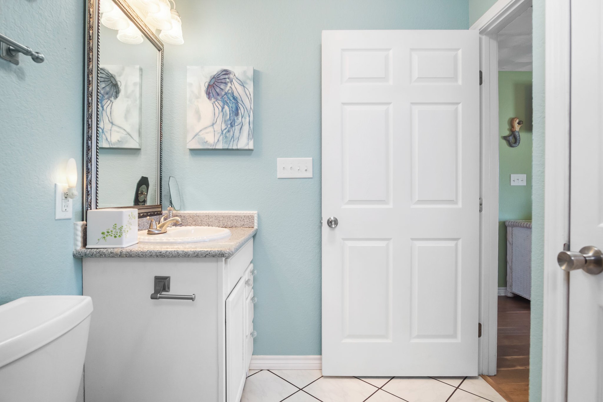 3297 Prides Way Crystal Beach, TX 77650 - Photo 26 of 42 a bathroom with a granite countertop sink and a toilet