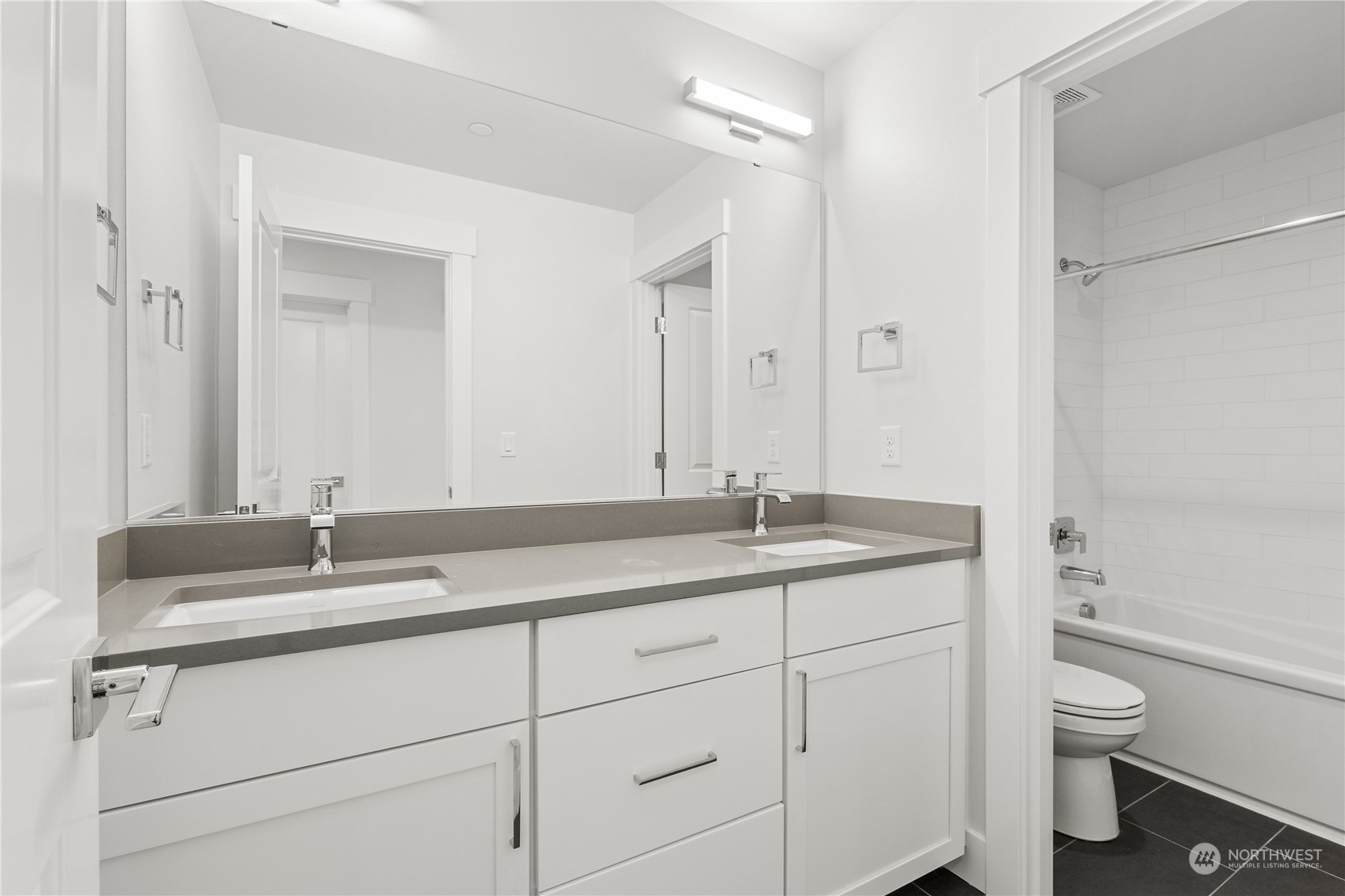 2421 242nd Place Southeast, Unit 9 Bothell, WA 98021 - Photo 14 of 15 a bathroom with a granite countertop sink a toilet and a mirror