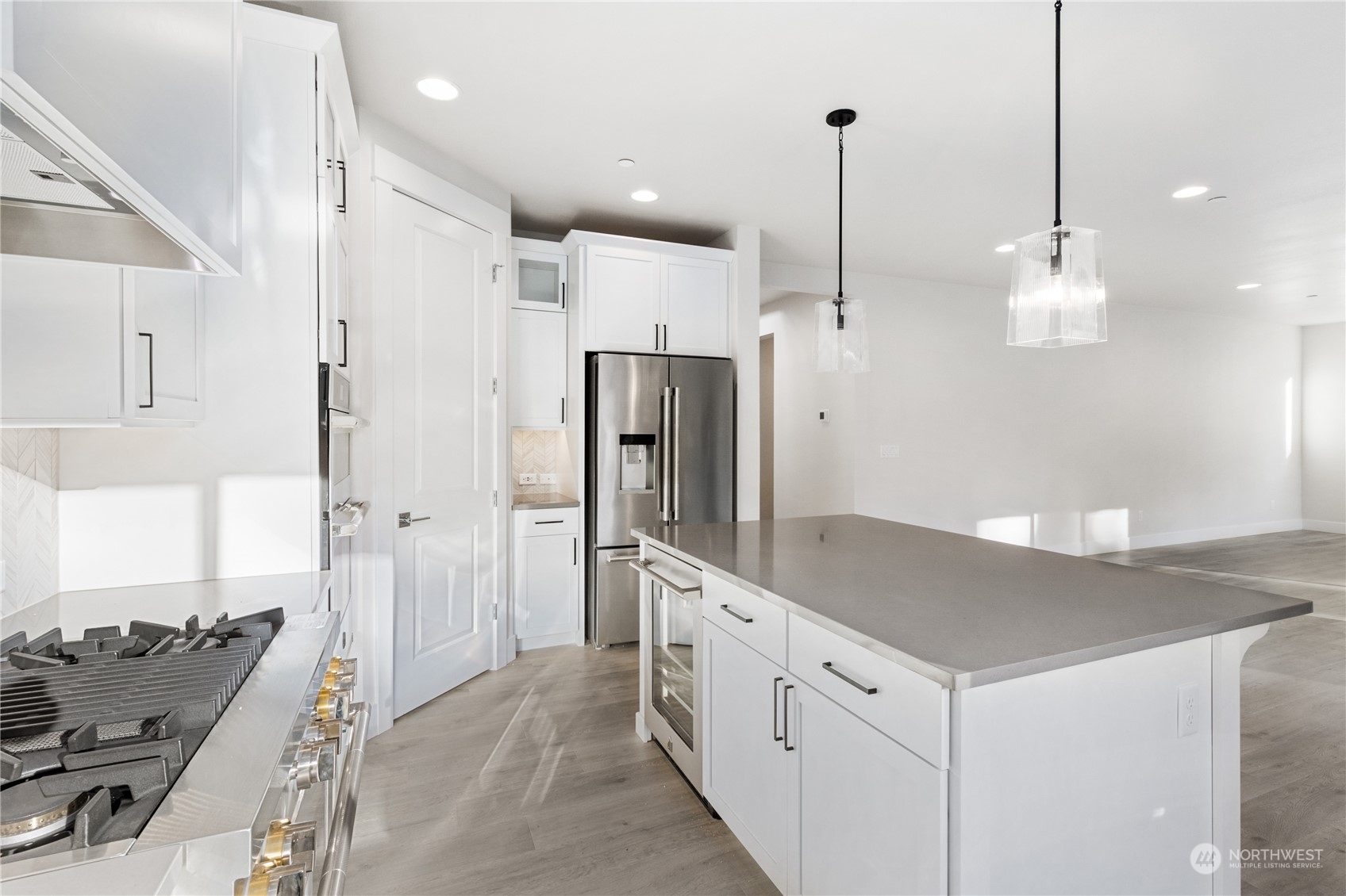 2421 242nd Place Southeast, Unit 9 Bothell, WA 98021 - Photo 3 of 15 a kitchen with stainless steel appliances kitchen island granite countertop a refrigerator a sink and a stove