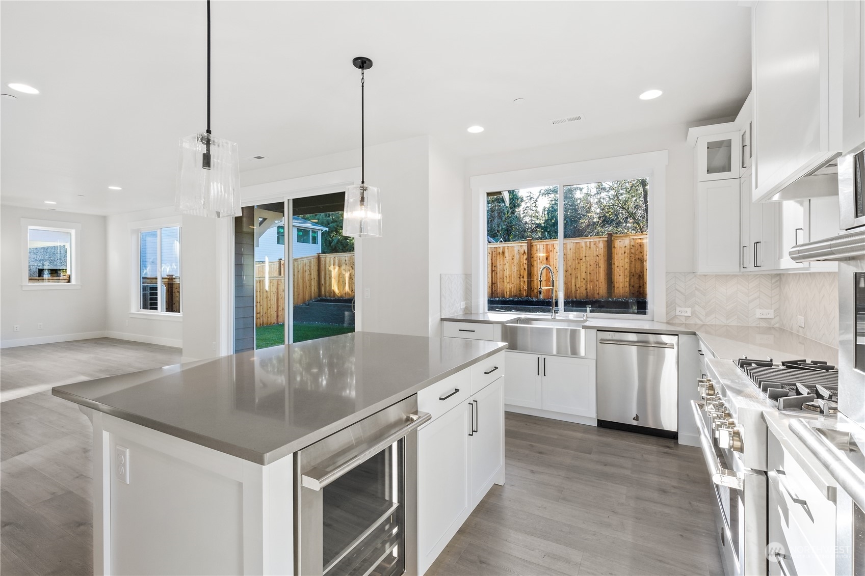 2421 242nd Place Southeast, Unit 9 Bothell, WA 98021 - Photo 5 of 15 a kitchen with white cabinets and stainless steel appliances