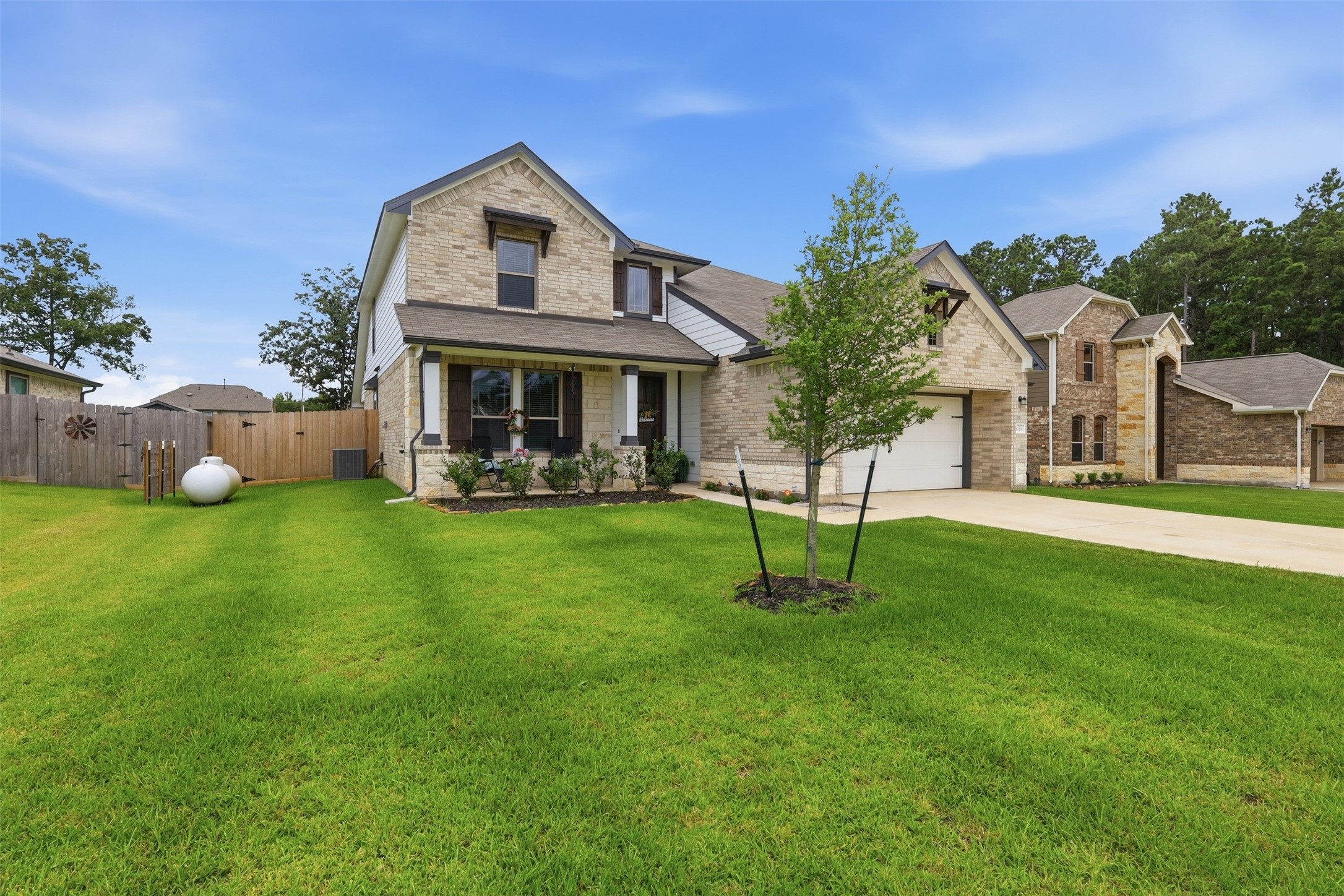 6310 Fawn Path Drive Conroe, TX 77303 - Photo 3 of 41 Beautiful curb appeal with attractive brick-and-stone construction and a well-maintained lawn.