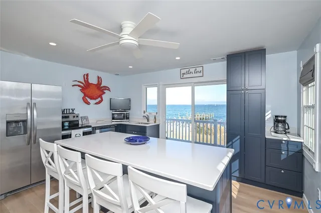 a kitchen with a table chairs refrigerator and cabinets