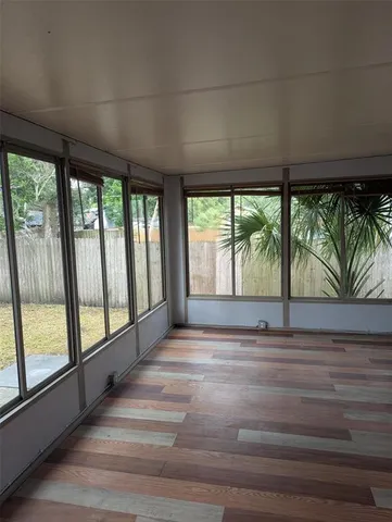 a view of empty room with large windows