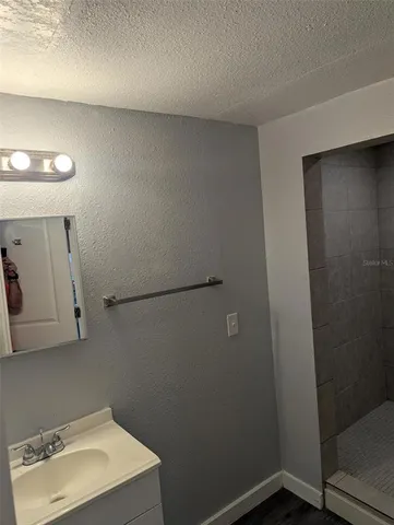 a bathroom with a sink a mirror and vanity