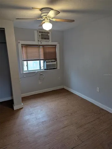 a view of wooden floor and a chandelier in a room