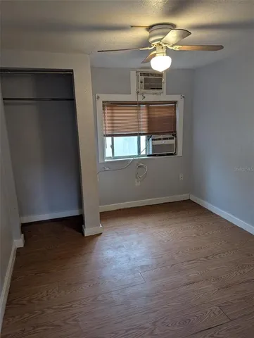 wooden floor chandelier and window in a room