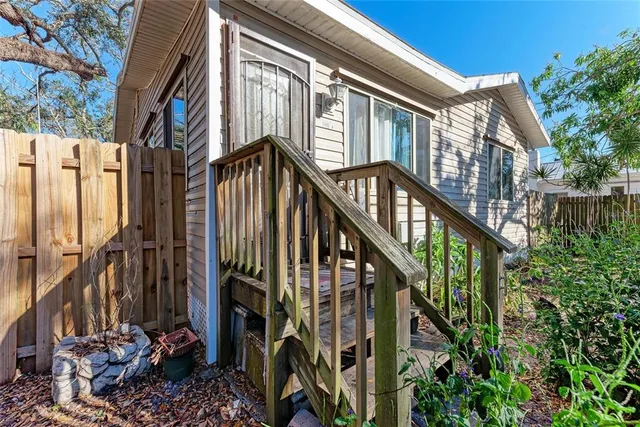 a view of a house with backyard and deck