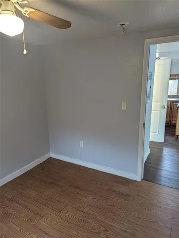 a view of a small space with wooden floor and a window