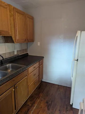 a kitchen with stainless steel appliances granite countertop a sink refrigerator and cabinets