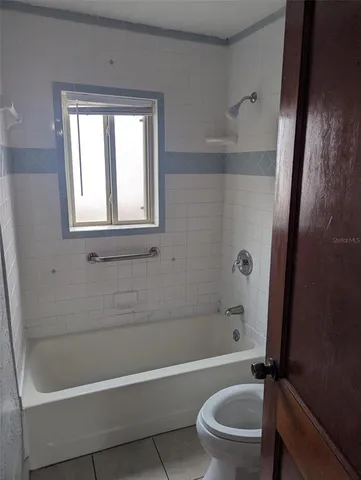 a bathroom with a bathtub a toilet and a shower