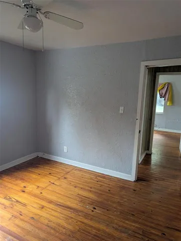 a view of a room with wooden floor
