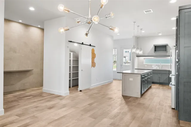 a large kitchen with a large counter top appliances and cabinets