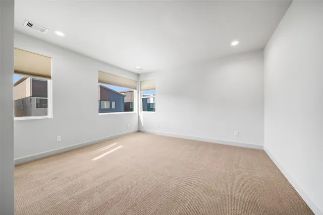 an empty room with a empty space and windows