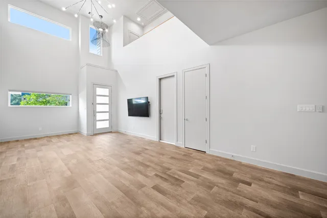 a view of empty room with window and ceiling fan