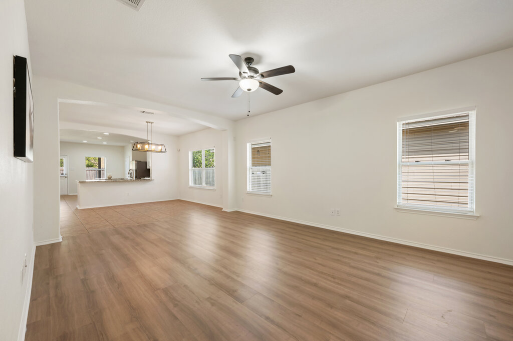 11744 Easy Street Austin, TX 78748 - Photo 8 of 40 Gleaming wood floors anchor an airy, open layout flowing seamlessly toward the kitchen.