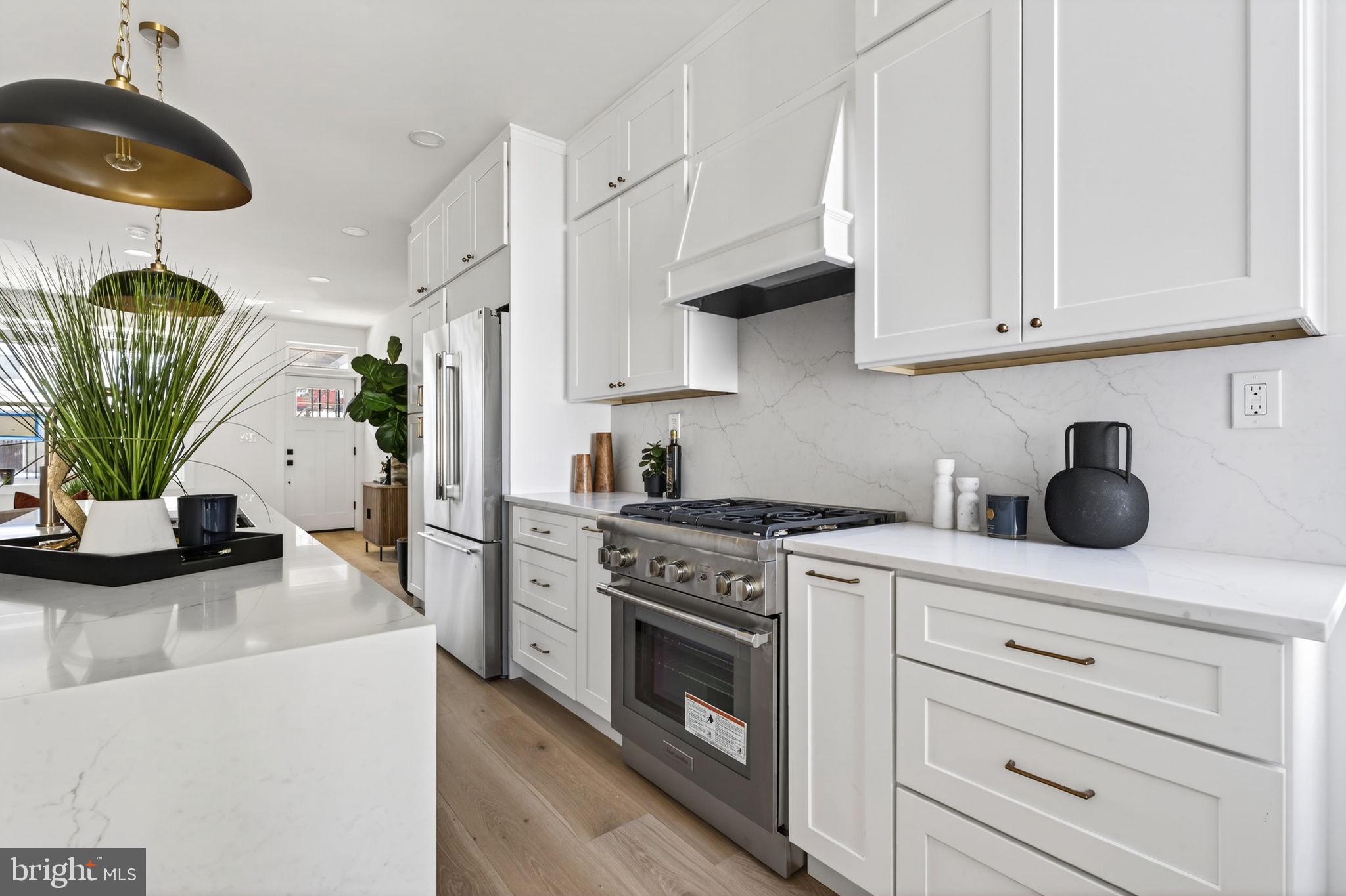 609 Harvard Street Northwest Washington, DC 20001 - Photo 12 of 41 a kitchen with stainless steel appliances white cabinets and a stove