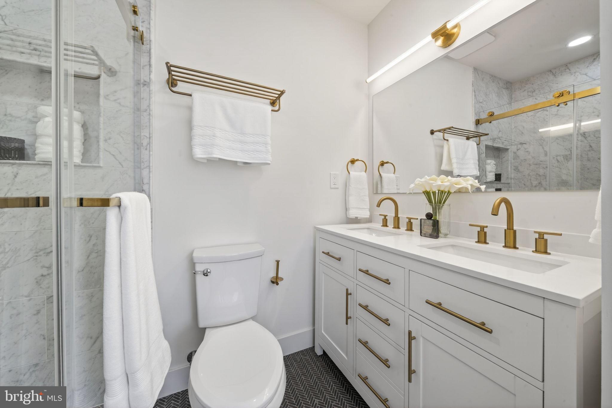 609 Harvard Street Northwest Washington, DC 20001 - Photo 21 of 41 a bathroom with a toilet sink and mirror