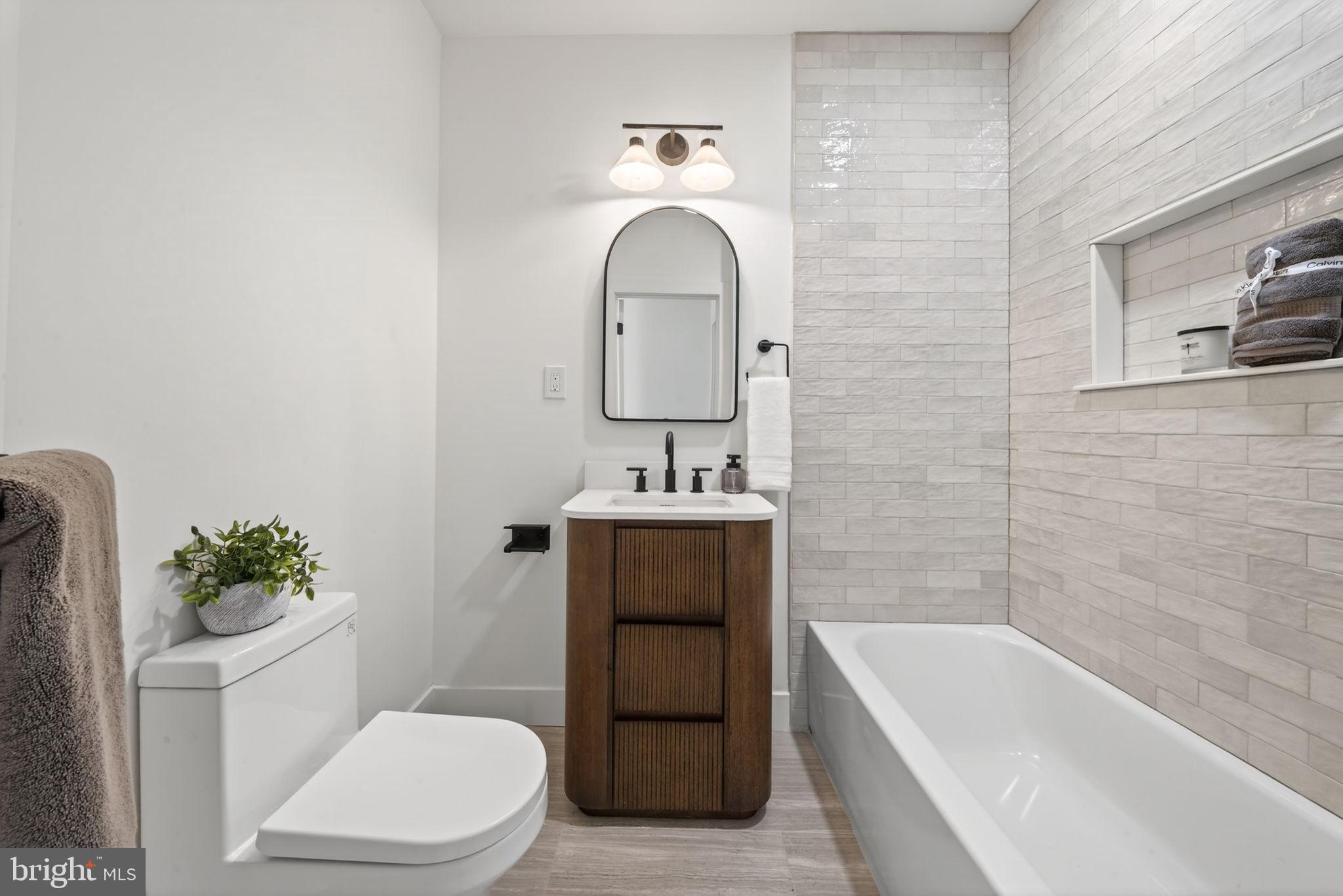 609 Harvard Street Northwest Washington, DC 20001 - Photo 24 of 41 a bathroom with a sink a toilet and shower