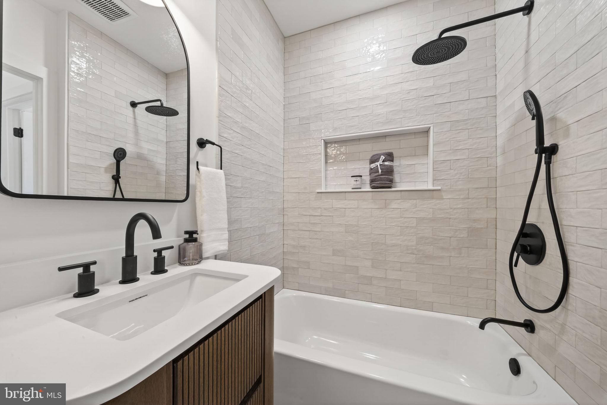 609 Harvard Street Northwest Washington, DC 20001 - Photo 25 of 41 a bathroom with a granite countertop sink a toilet and mirror