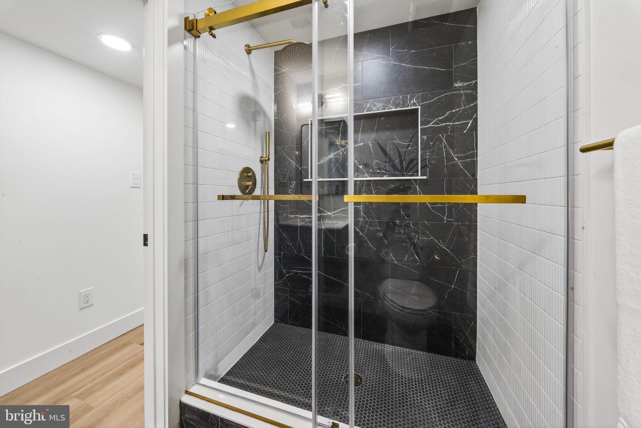 609 Harvard Street Northwest Washington, DC 20001 - Photo 34 of 41 a bathroom with a glass shower door