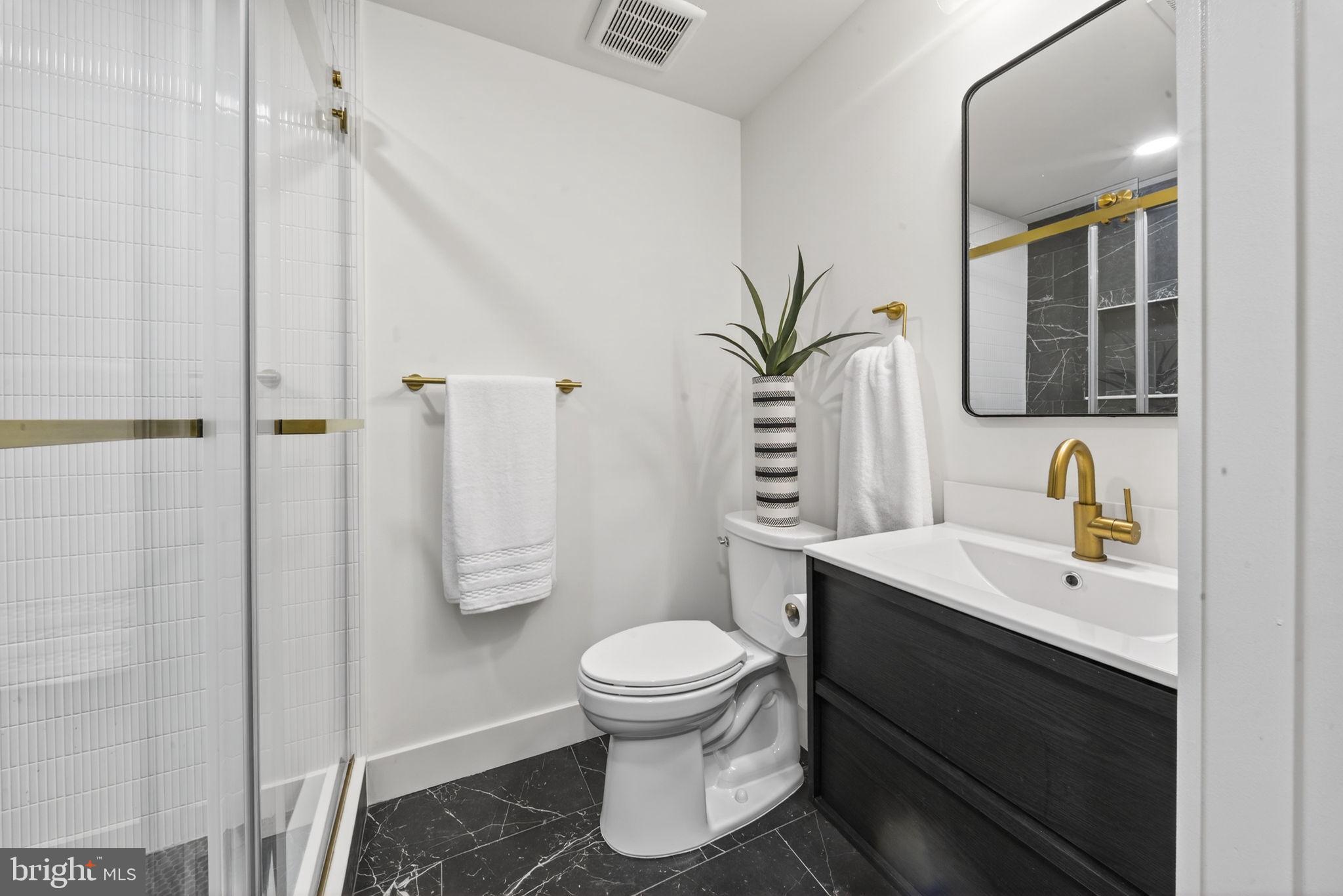 609 Harvard Street Northwest Washington, DC 20001 - Photo 35 of 41 a bathroom with a sink toilet and shower
