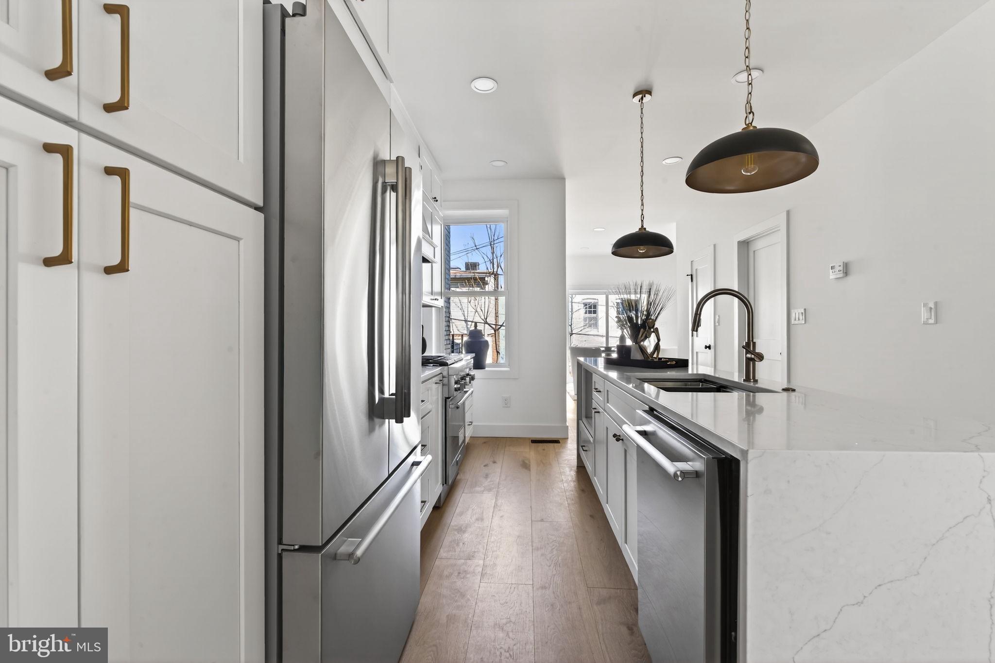 609 Harvard Street Northwest Washington, DC 20001 - Photo 10 of 41 a kitchen with stainless steel appliances granite countertop a stove a refrigerator and a sink