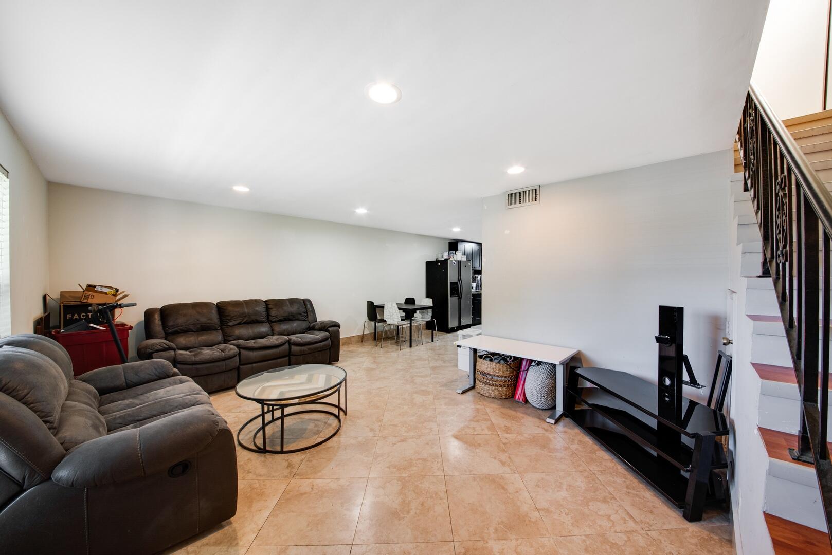 1945 Northwest 4th Avenue, Unit 30 Boca Raton, FL 33432 - Photo 11 of 30 a living room with furniture gym equipment and a flat screen tv