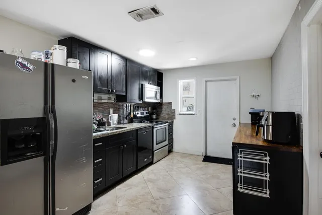 a kitchen with stainless steel appliances a refrigerator stove and sink