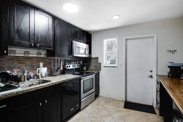 a kitchen with a sink stove and refrigerator