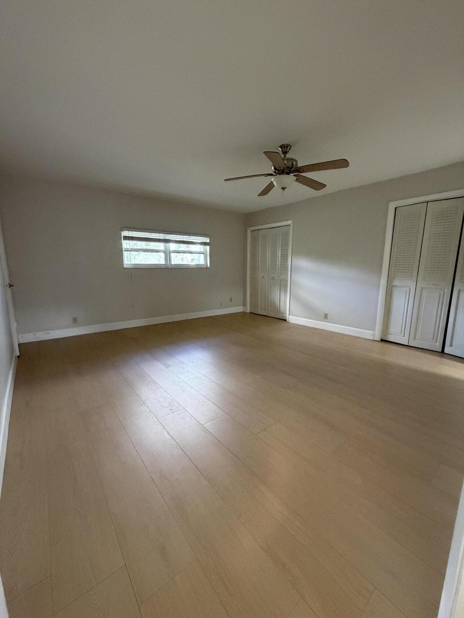 1945 Northwest 4th Avenue, Unit 30 Boca Raton, FL 33432 - Photo 24 of 30 an empty room with windows and fan