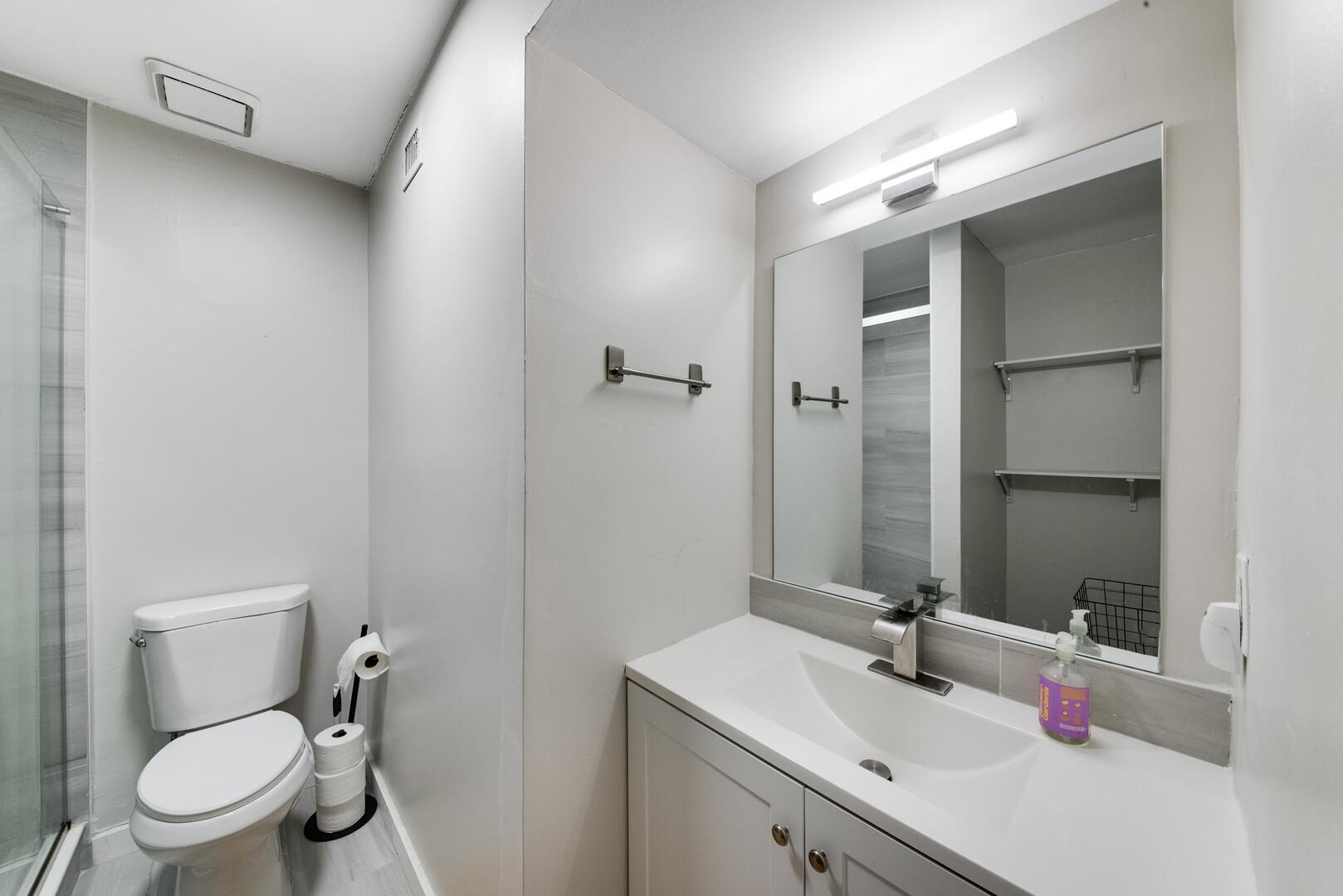 1945 Northwest 4th Avenue, Unit 30 Boca Raton, FL 33432 - Photo 26 of 30 a bathroom with a sink toilet vanity and shower