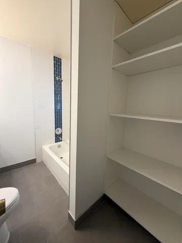 a room with a white bed and a white door