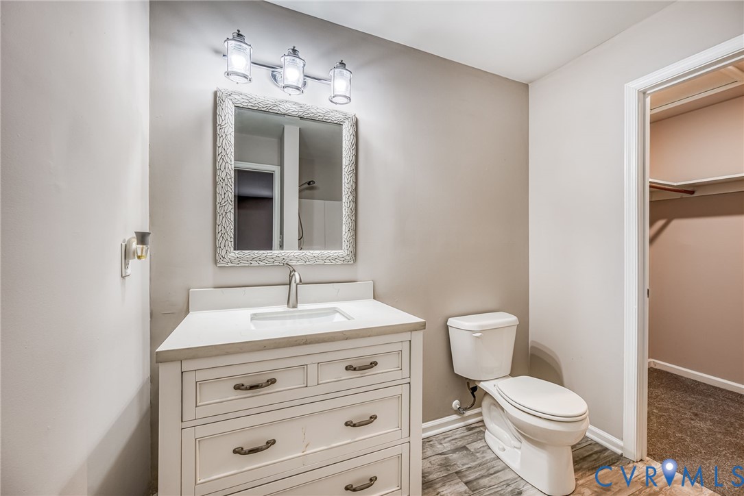 7045 Tranquility Lane Sutherland, VA 23885 - Photo 13 of 27 a bathroom with a toilet sink and mirror