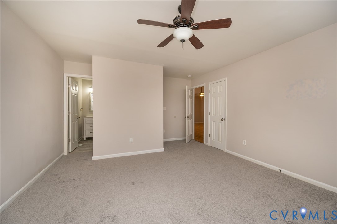 7045 Tranquility Lane Sutherland, VA 23885 - Photo 15 of 27 an empty room with chandelier fan