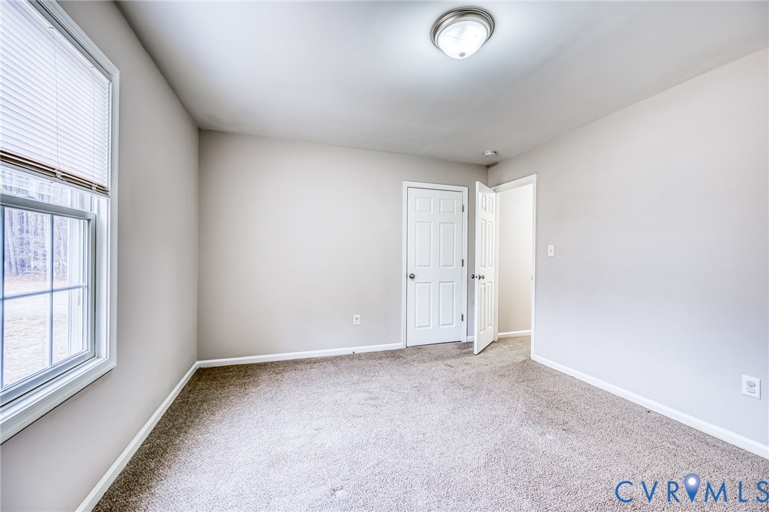 7045 Tranquility Lane Sutherland, VA 23885 - Photo 20 of 27 an empty room with windows