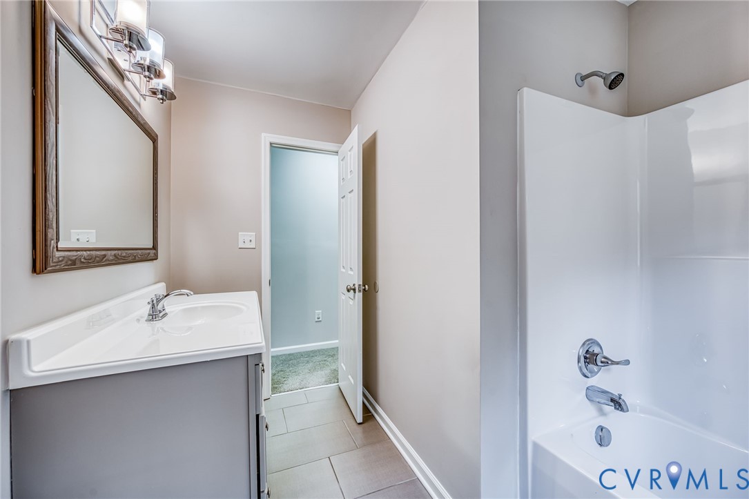 7045 Tranquility Lane Sutherland, VA 23885 - Photo 21 of 27 a bathroom with a sink and a mirror