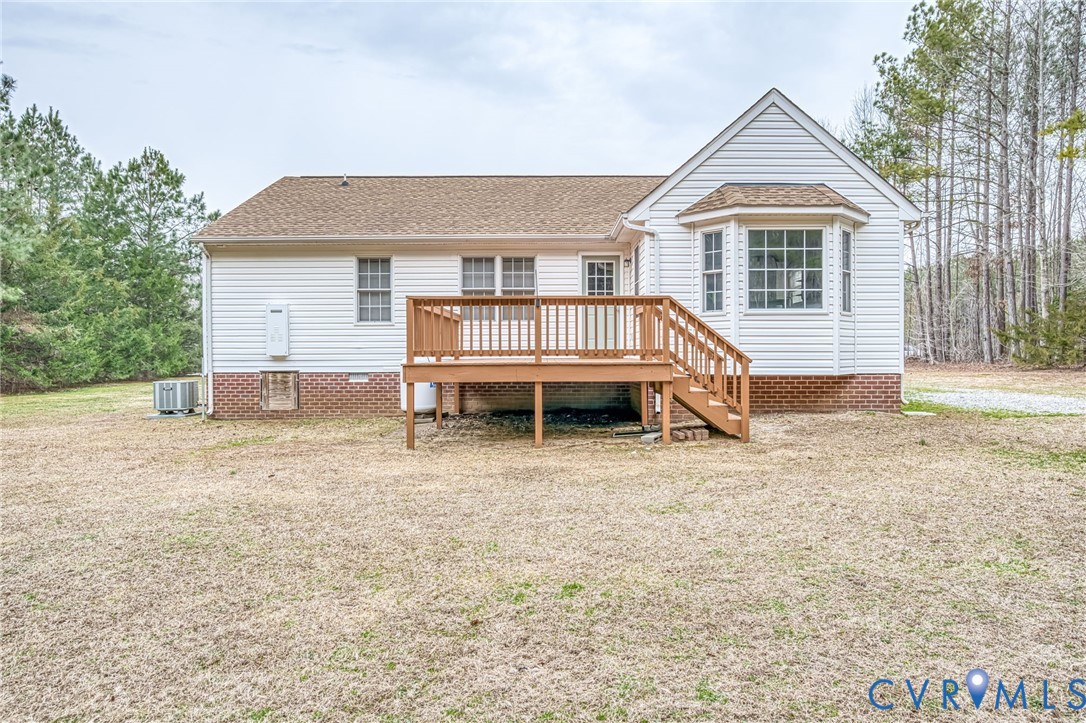 7045 Tranquility Lane Sutherland, VA 23885 - Photo 25 of 27 a backyard of a house with oven and outdoor seating