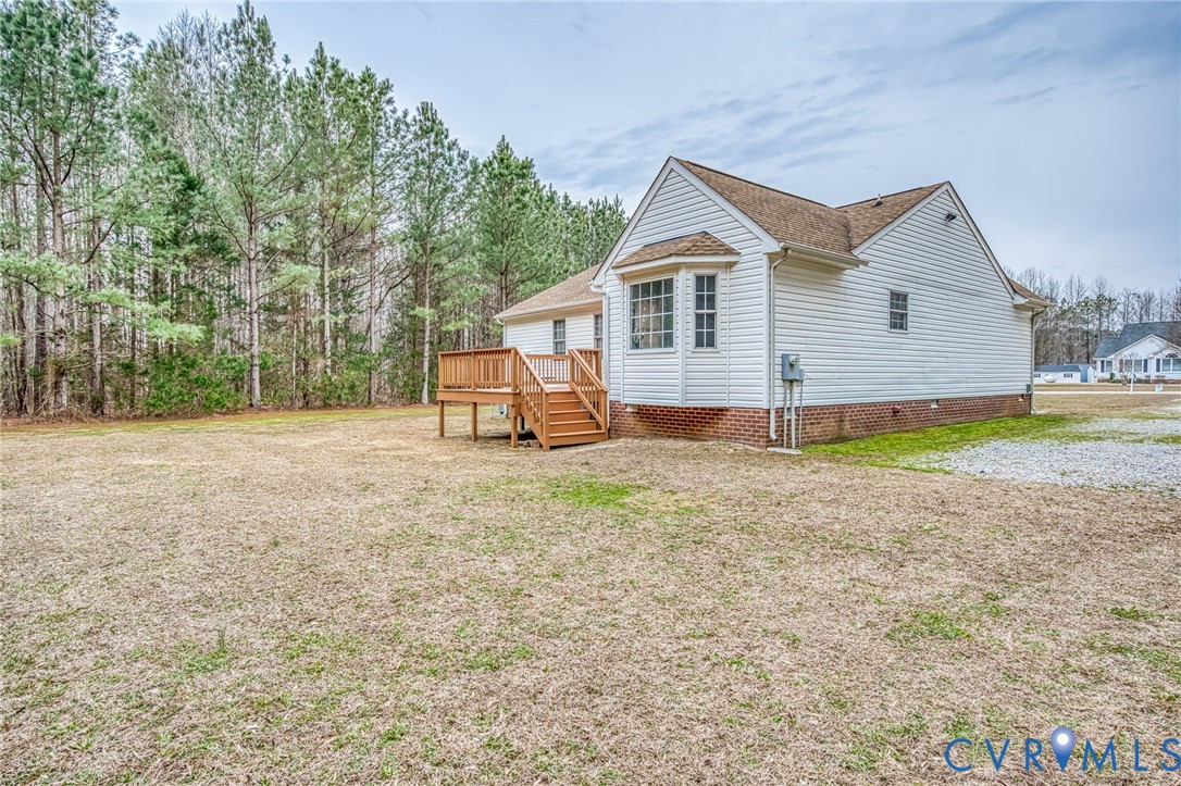 7045 Tranquility Lane Sutherland, VA 23885 - Photo 26 of 27 a view of a house with backyard and trees