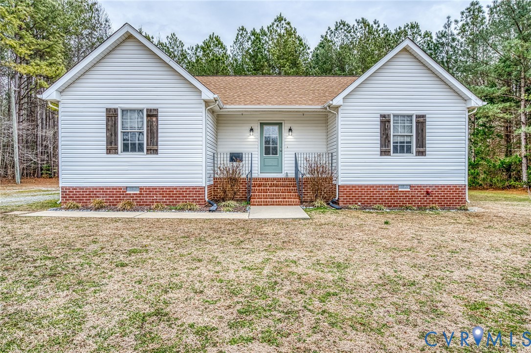 7045 Tranquility Lane Sutherland, VA 23885 - Photo 4 of 27 a front view of a house with a yard and garage
