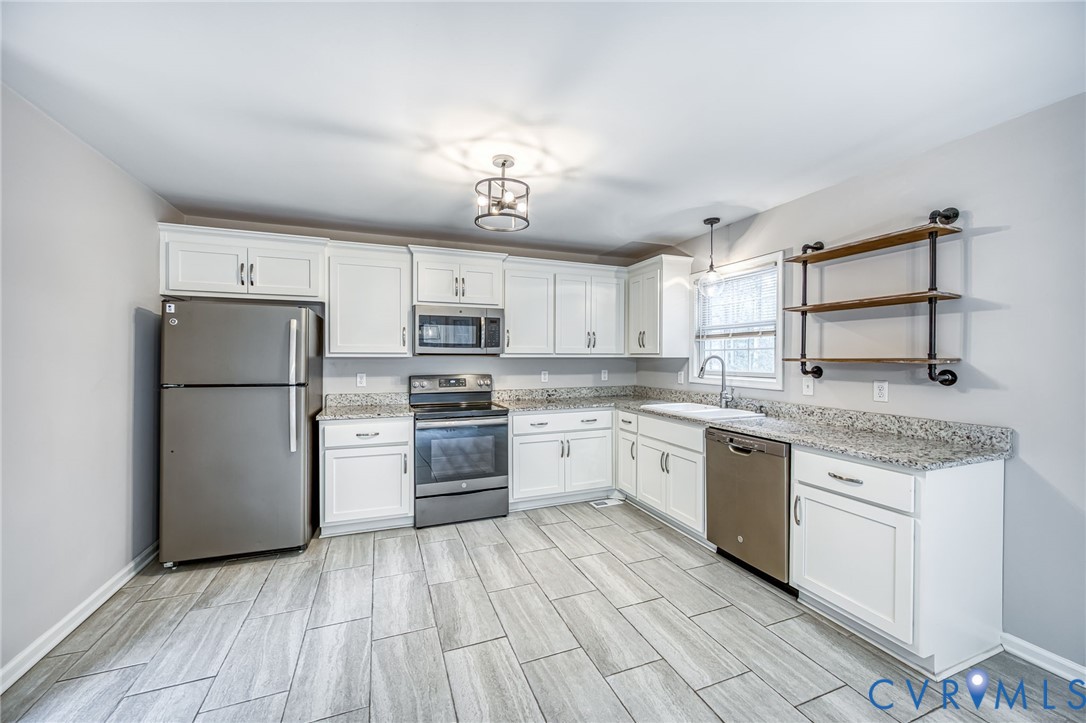 7045 Tranquility Lane Sutherland, VA 23885 - Photo 10 of 27 a kitchen with a sink stainless steel appliances and cabinets