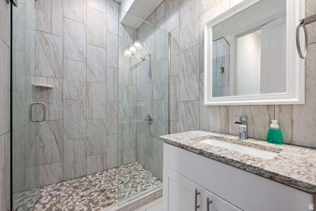 4281 Canterbury Road Hurricane, UT 84737 - Photo 9 of 24 Contemporary bathroom featuring a frameless glass shower enclosure with pebble floor tiles and large format wall tiles