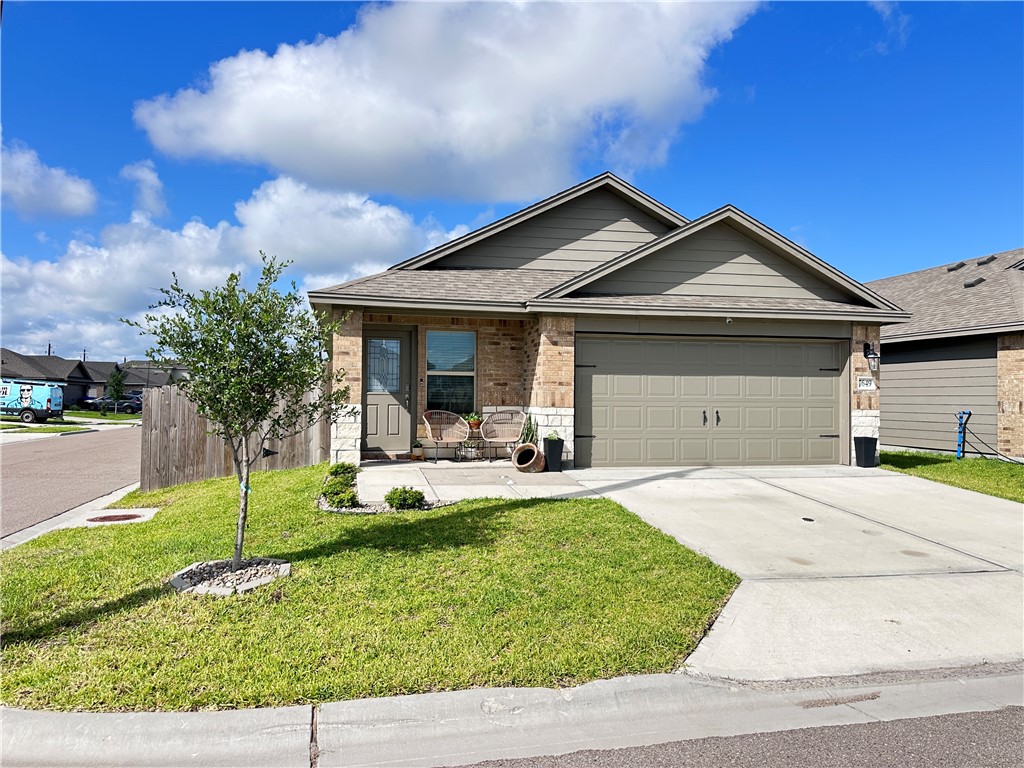 7649 Herd Rider Lane Corpus Christi, TX 78414 - Photo 18 of 18 a front view of a house with a garden and plants