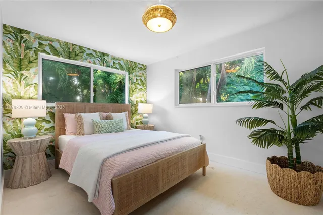 a bedroom with a bed and a large window