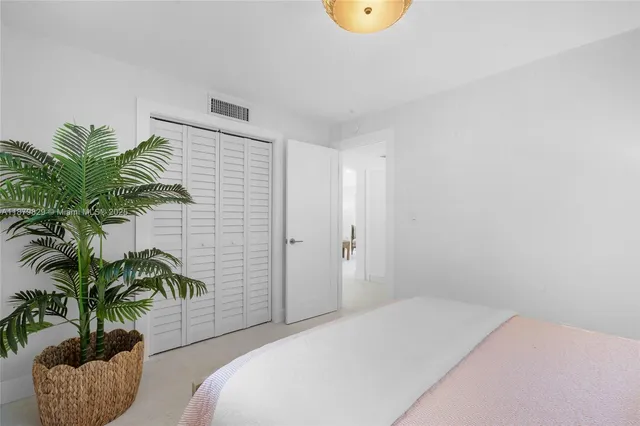 a bedroom with a potted plant and a potted plant