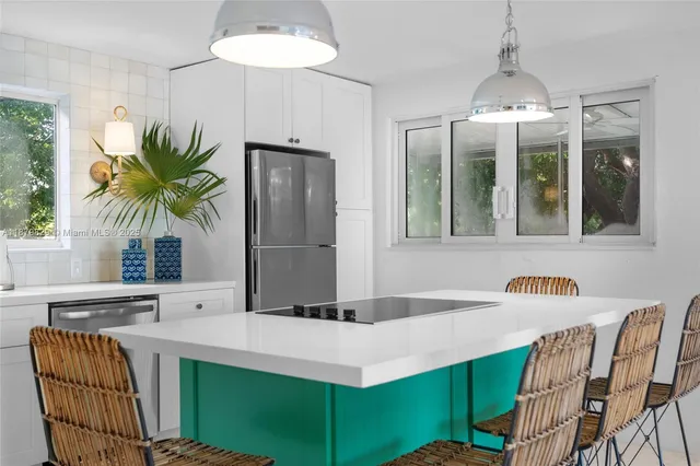 a kitchen with a table and chairs