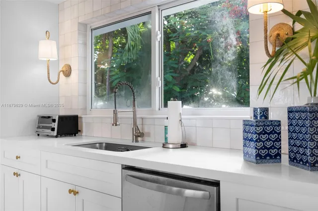a kitchen with a stove and a white cabinets